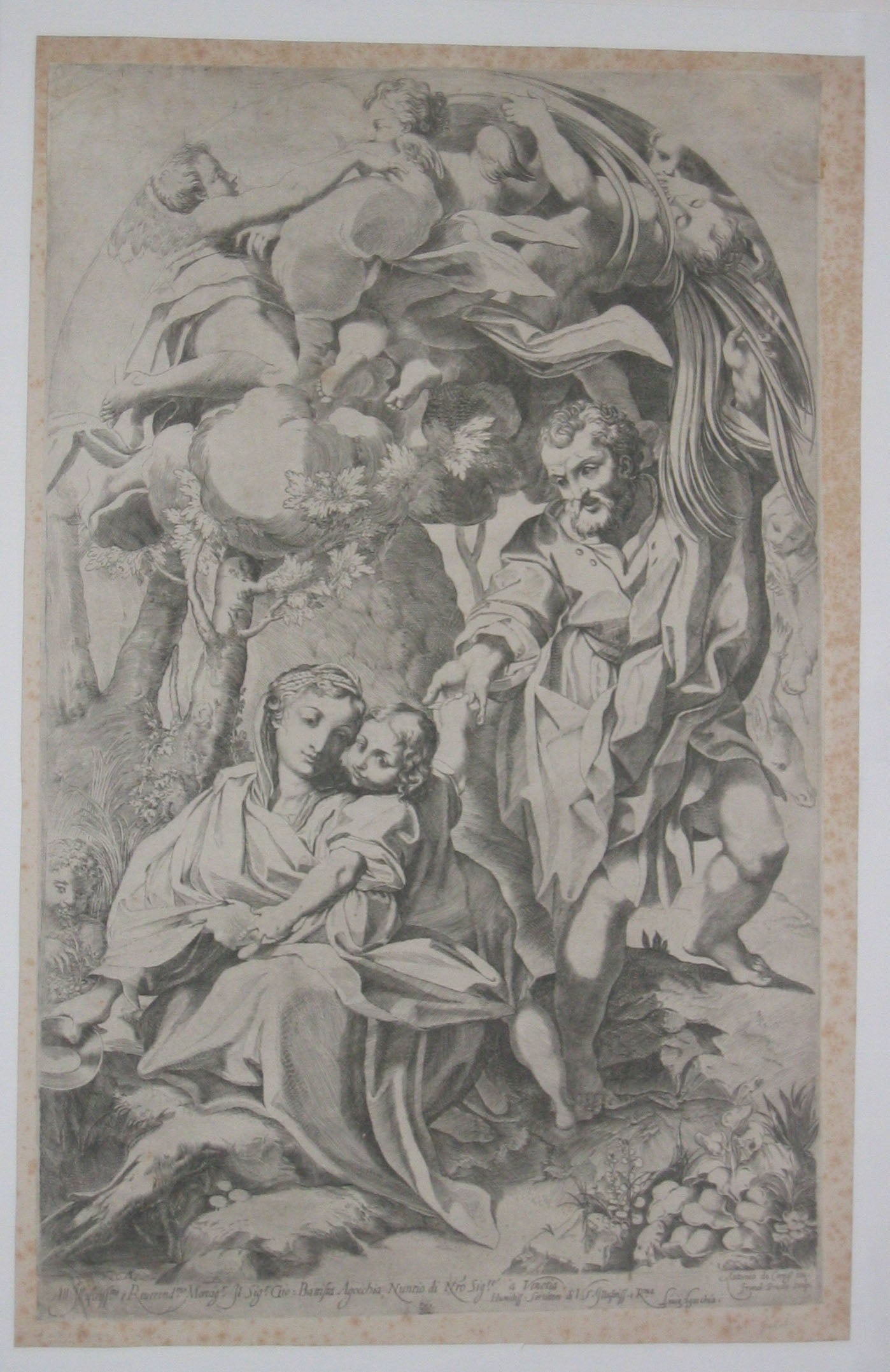 La Ste Vierge assise au bord d'une fontaine près de l'Enfant Jésus, à qui St Joseph donne des fruits.