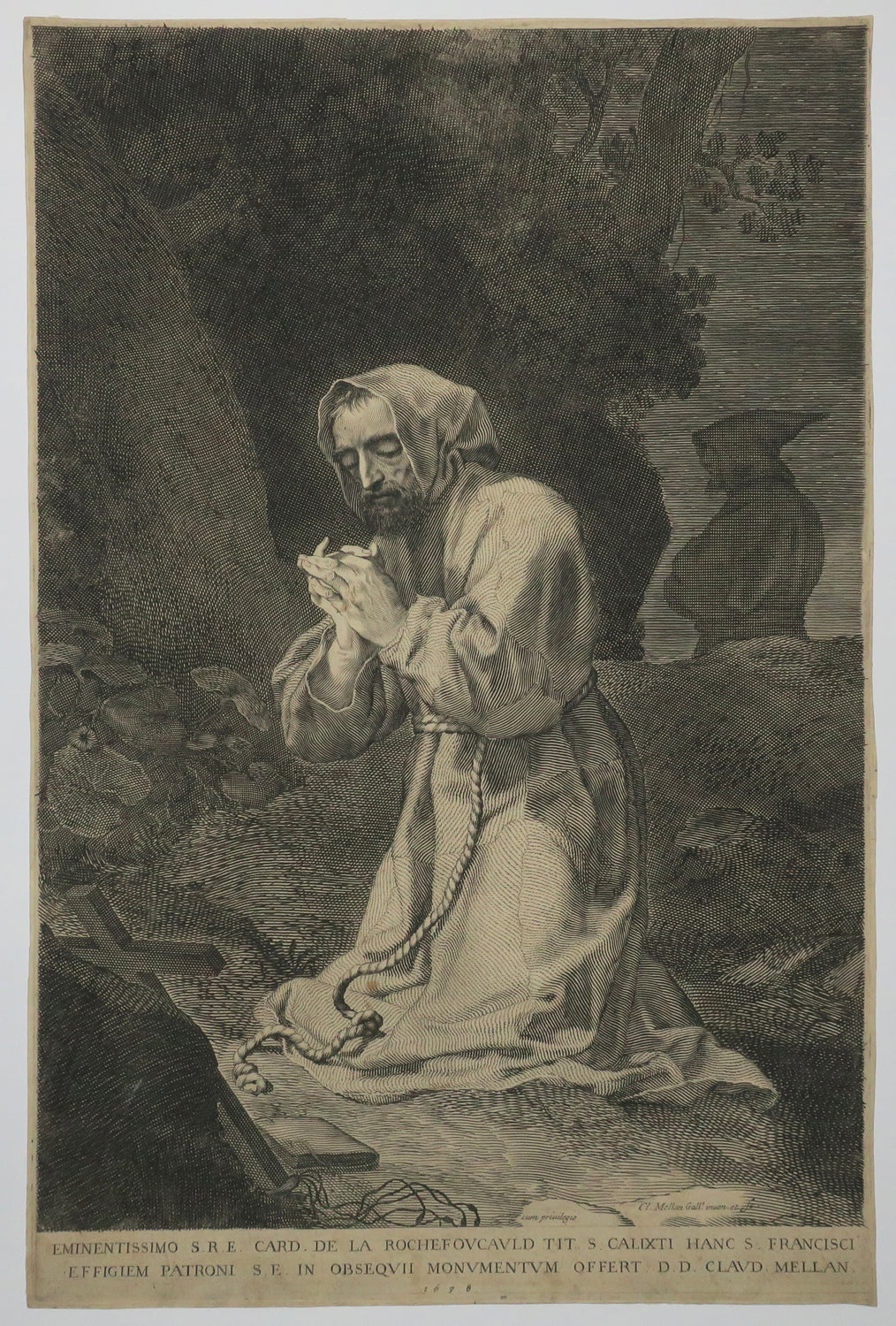 Saint François d'Assise à genoux devant un crucifix.